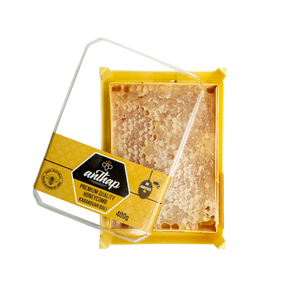 Packaged honeycomb with a yellow and black label on a white background