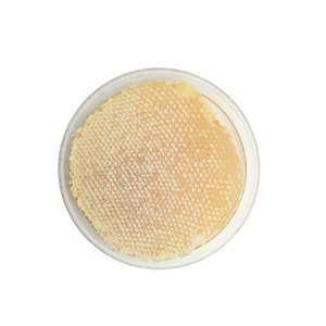 Round container with beige textured powder on a white background