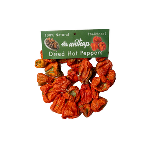 Dried hot peppers with a green label on a white background