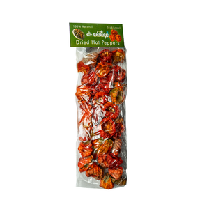 Packaged dried hot peppers with a green label on a white background