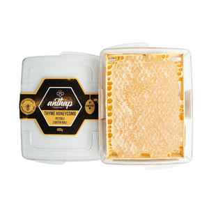 Thyme honeycomb in a clear container with a visible brand label on a white background